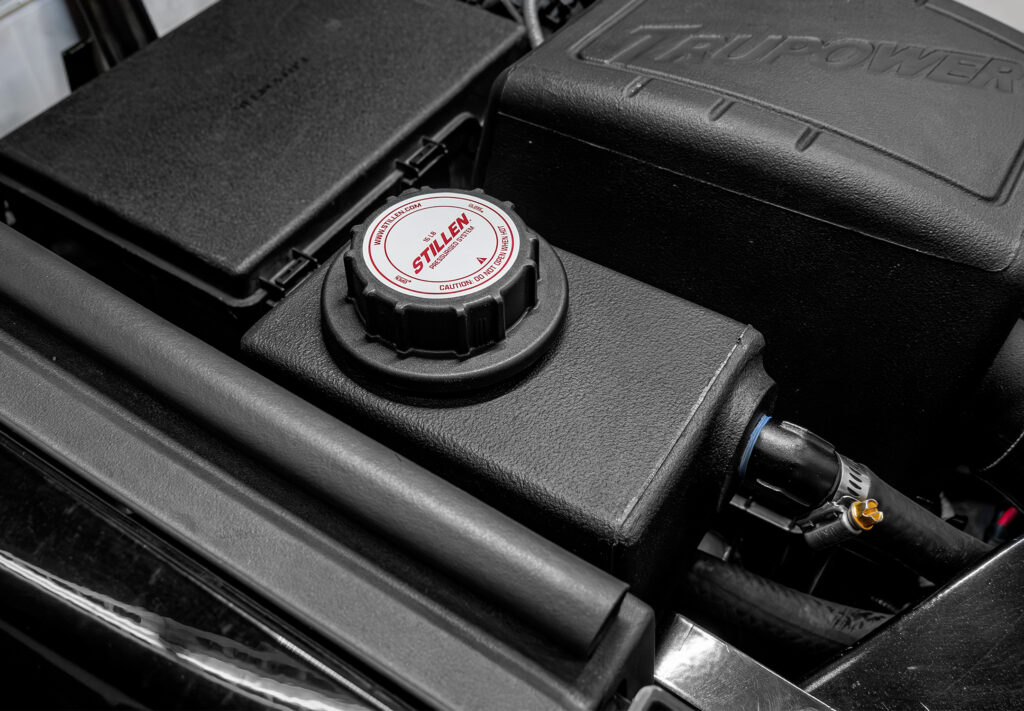 Close-up of STILLEN Tundra intercooler reservoir relocation kit components